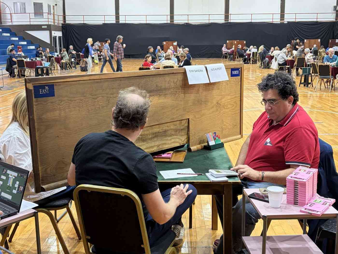Bridge tournament table during a duplicate session, illustrating bridge scoring in a real tournament setting.